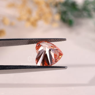 A loose 4 carat diamond in fancy vivid pink is crafted in a heart shape.
