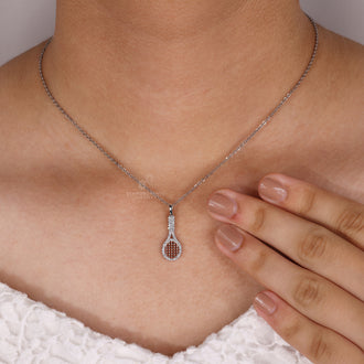 Diamondensu pendant with racket charm and prong set design.
