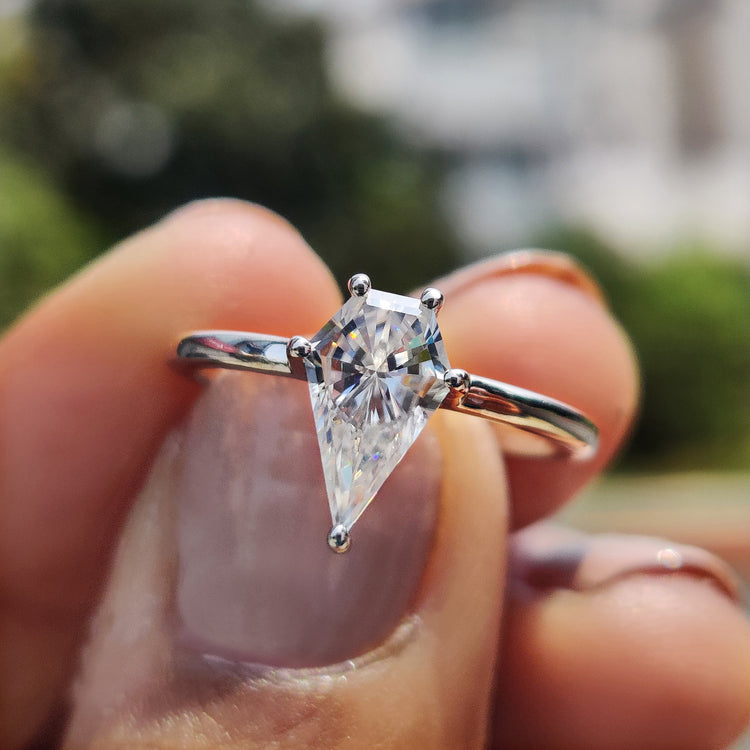 Moissanite solitaire ring with a sleek spear cut set in a classic white gold band.
