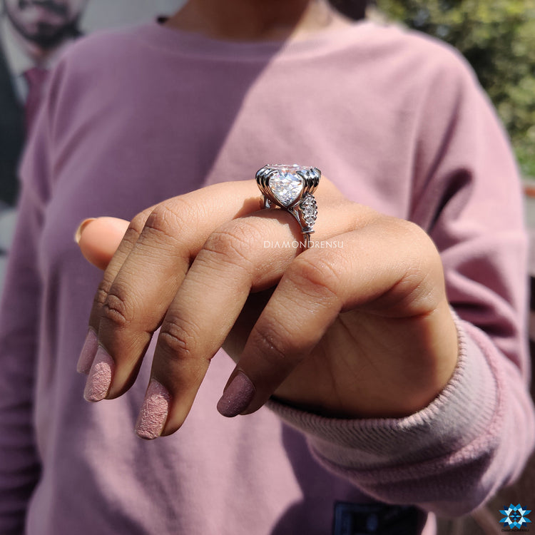 Fishtail prongs securing a dazzling moissanite stone.
