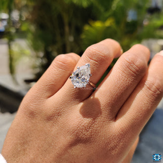 Diamondrensu ring with a Rensu pear cut moissanite center.
