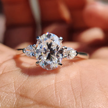 Oval engagement ring with pear side stones.
