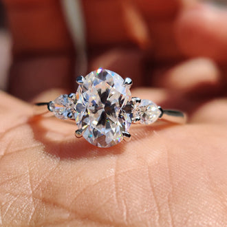 Oval engagement ring with pear side stones.
