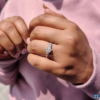 Prong setting engagement ring with round cut side stones in white gold