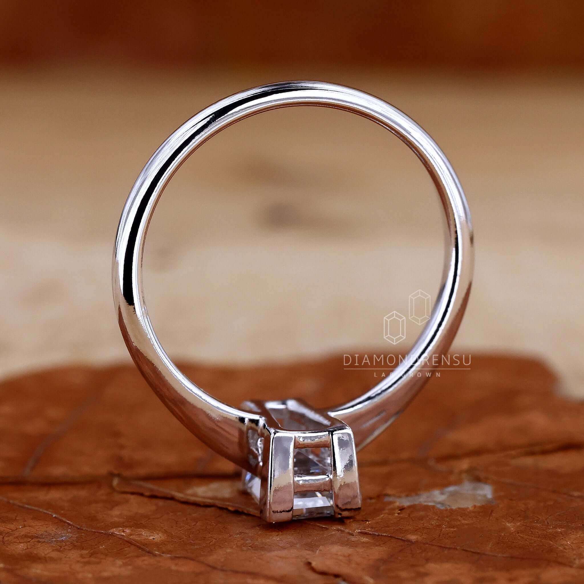 Engagement ring with a central diamond and baguette stones in a basket setting