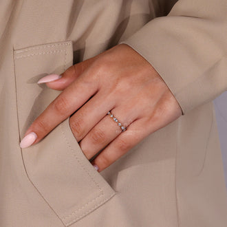 Yellow gold wedding band with prong-set diamonds.
