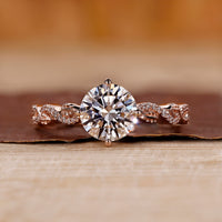Round diamond engagement ring with a Compass Prong Setting design.
