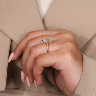 Hidden Halo Engagement Ring featuring a round diamond with a cathedral setting in yellow gold.
