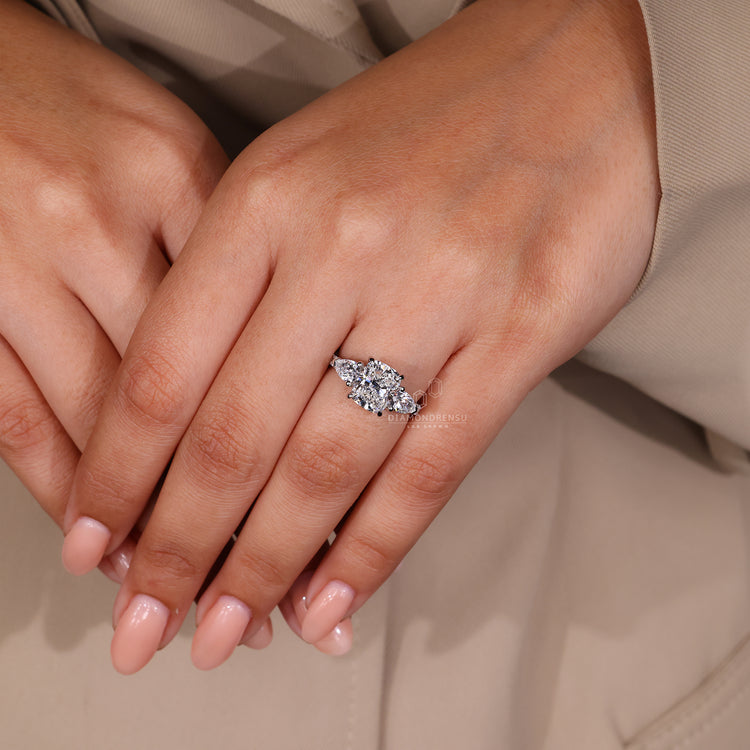 Lab grown diamond with 2 pear cut side stones and pave band.
