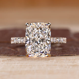 Elongated cushion ring with pave setting in round cut pave band.
