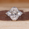 3 stone diamond ring with oval cut center diamond and half moon cut side stones.
