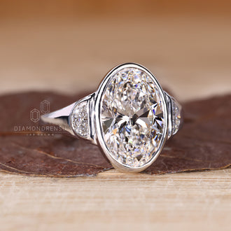Handmade ring with oval cut center diamond and half moon cut side stones.
