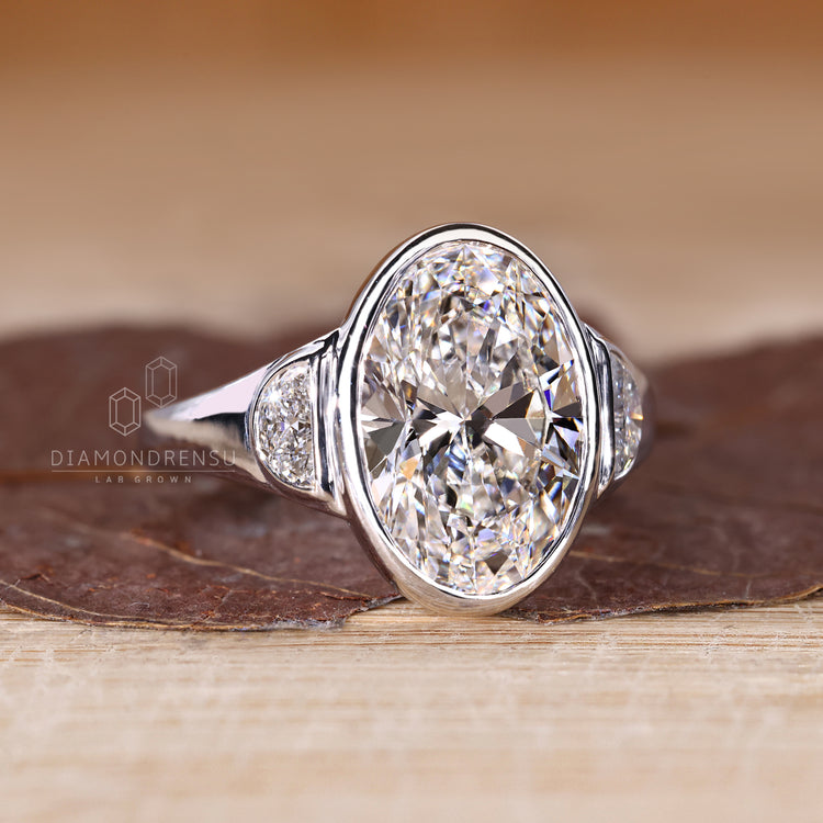 Handmade ring with oval cut center diamond and half moon cut side stones.
