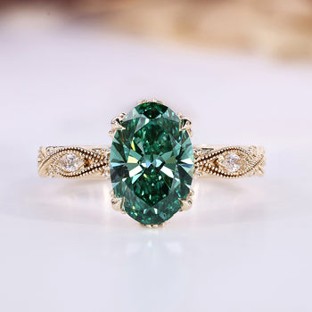 Oval cut diamond ring with green center stone and round side stones.