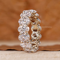 Oval diamond wedding band with stackable design and shared prongs.