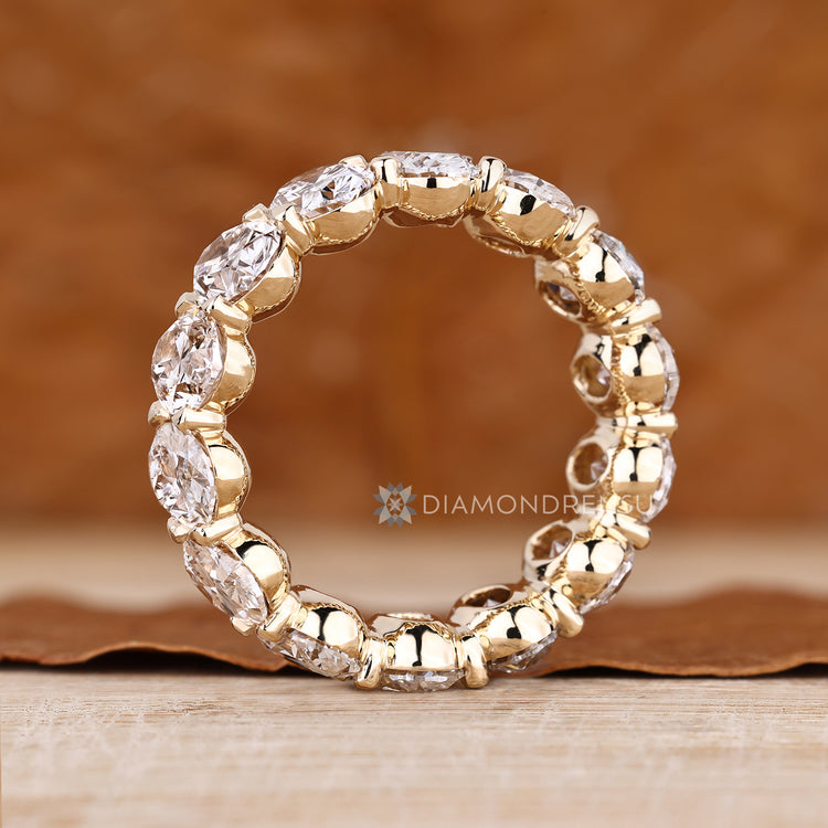 Full eternity band with shared prong oval diamond arrangement.