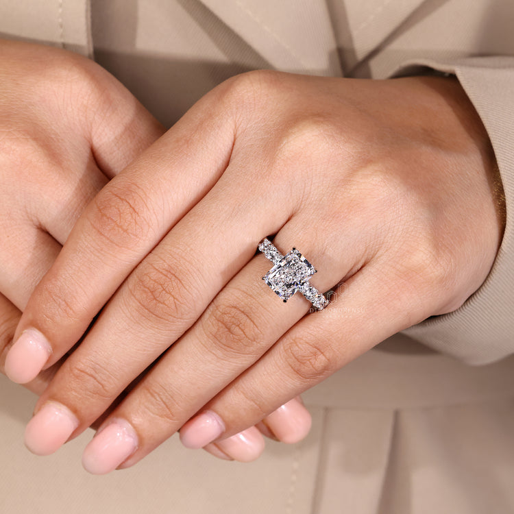 White gold ring with radiant diamond and 4 claw prong setting.
