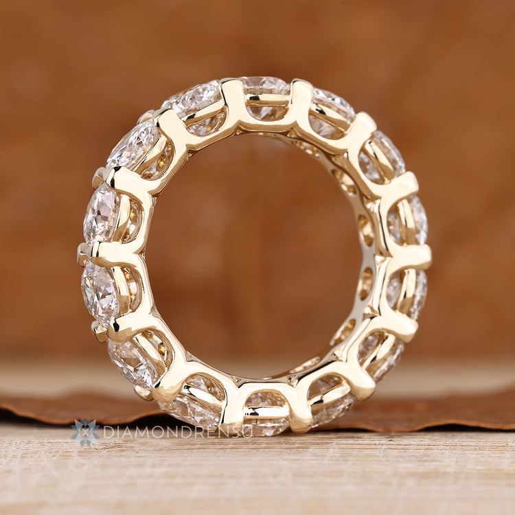 Handmade round diamond band with basket and shared prong setting.