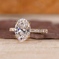 IGI certified oval hidden halo ring with round cut accents.

