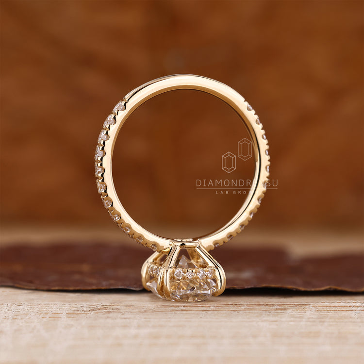Lab Grown Diamond oval engagement ring with hidden halo and round cut design.
