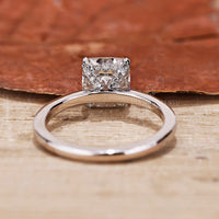 A cushion cut hidden halo engagement ring with exquisite details, ideal for a romantic proposal.
