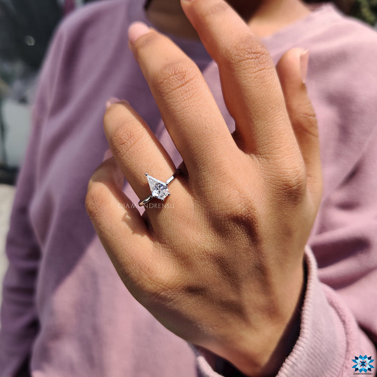 White gold ring with a shimmering moissanite solitaire in a classic prong setting.
