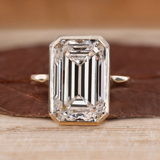 Bezel set emerald cut diamond ring.
