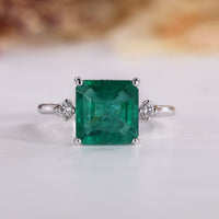 Asscher Cut Emerald Ring with tapered shank design.
