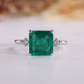 Asscher Cut Emerald Ring with tapered shank design.

