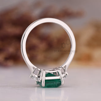 Emerald cut diamond ring in cathedral setting design.
