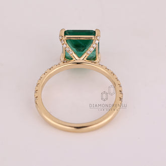 Custom emerald and diamond engagement ring.
