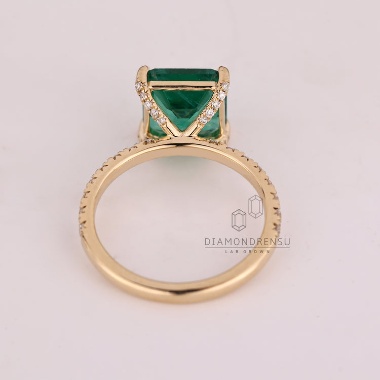 Custom emerald and diamond engagement ring.
