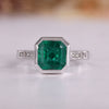 Asscher cut emerald ring in white gold.
