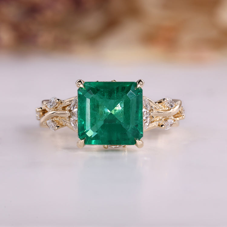 Nature inspired engagement ring with emerald gemstone.
