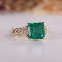 Yellow gold emerald gemstone engagement ring.
