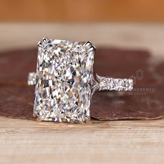 Pave diamond ring with radiant cut center stone.
