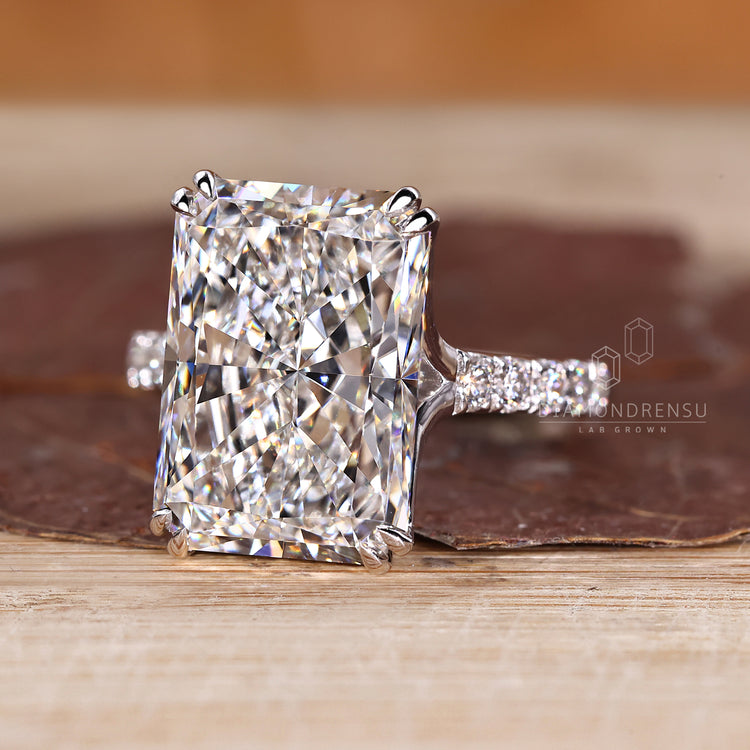 Pave diamond ring with radiant cut center stone.
