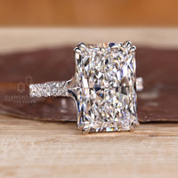 Radiant cut diamond ring with double claw prong setting.
