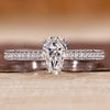 Coffin cut diamond ring with pave style band and round diamond accents.