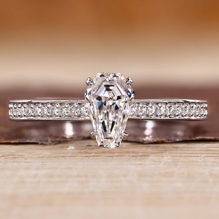 Coffin cut diamond ring with pave style band and round diamond accents.