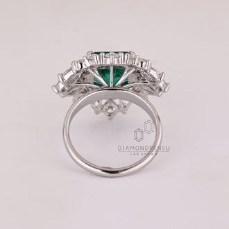 Custom emerald and diamond engagement ring.
