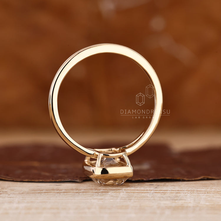Cushion old mine cut diamond in solitaire split shank ring.