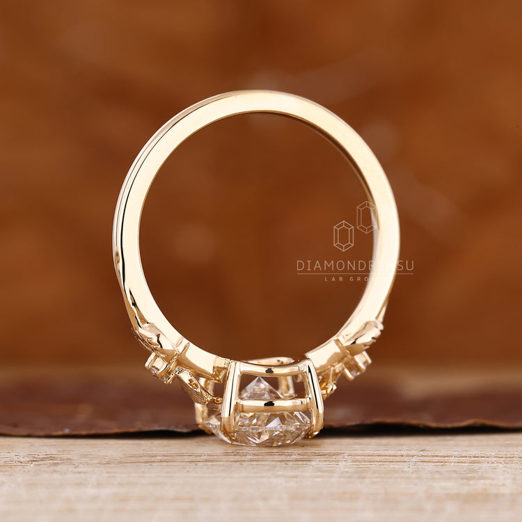 Lab Grown Diamond ring featuring leaf style prong and side stones.
