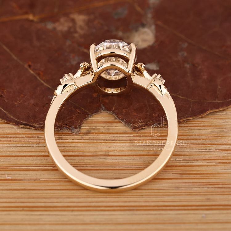 Handmade jewelry featuring nature inspired design and oval diamond.
