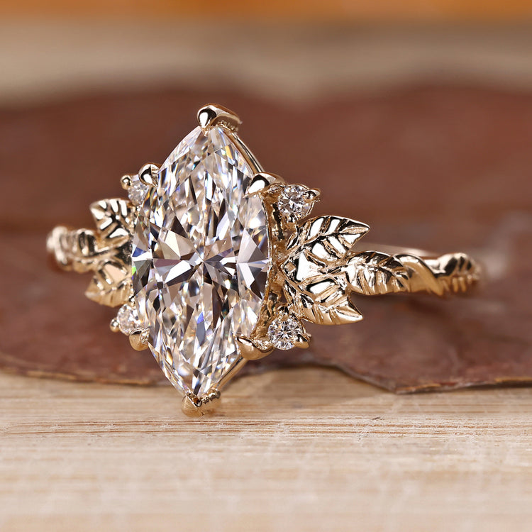 IGI certified nature inspired engagement ring with marquise center diamond.
