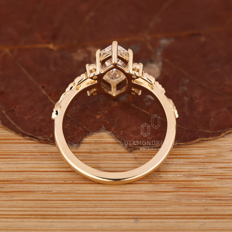 Handmade jewelry engagement ring with marquise diamond and side stone accents.
