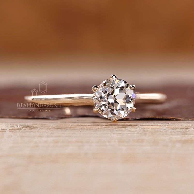 Round old European cut diamond solitaire in tulip design.