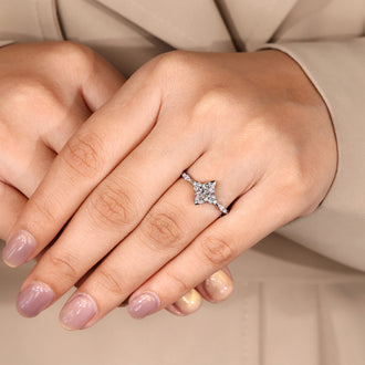 Muse setting engagement ring with marquise diamond and side stones.
