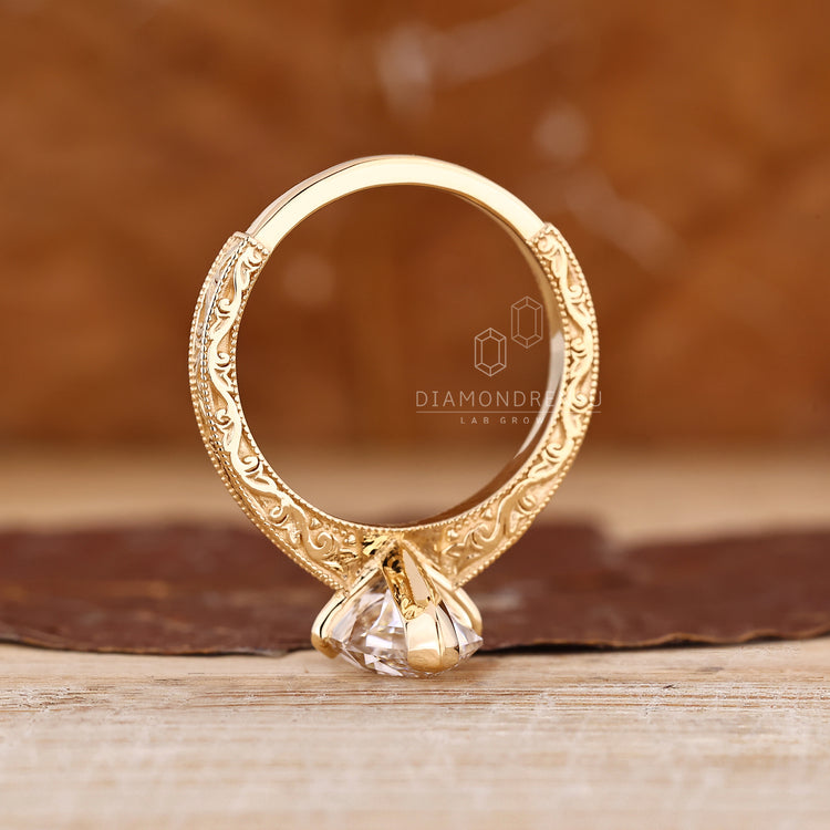 Milgrain setting Dutch marquise engagement ring in yellow gold.
