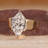 Solitaire diamond ring with six claw prong setting.
